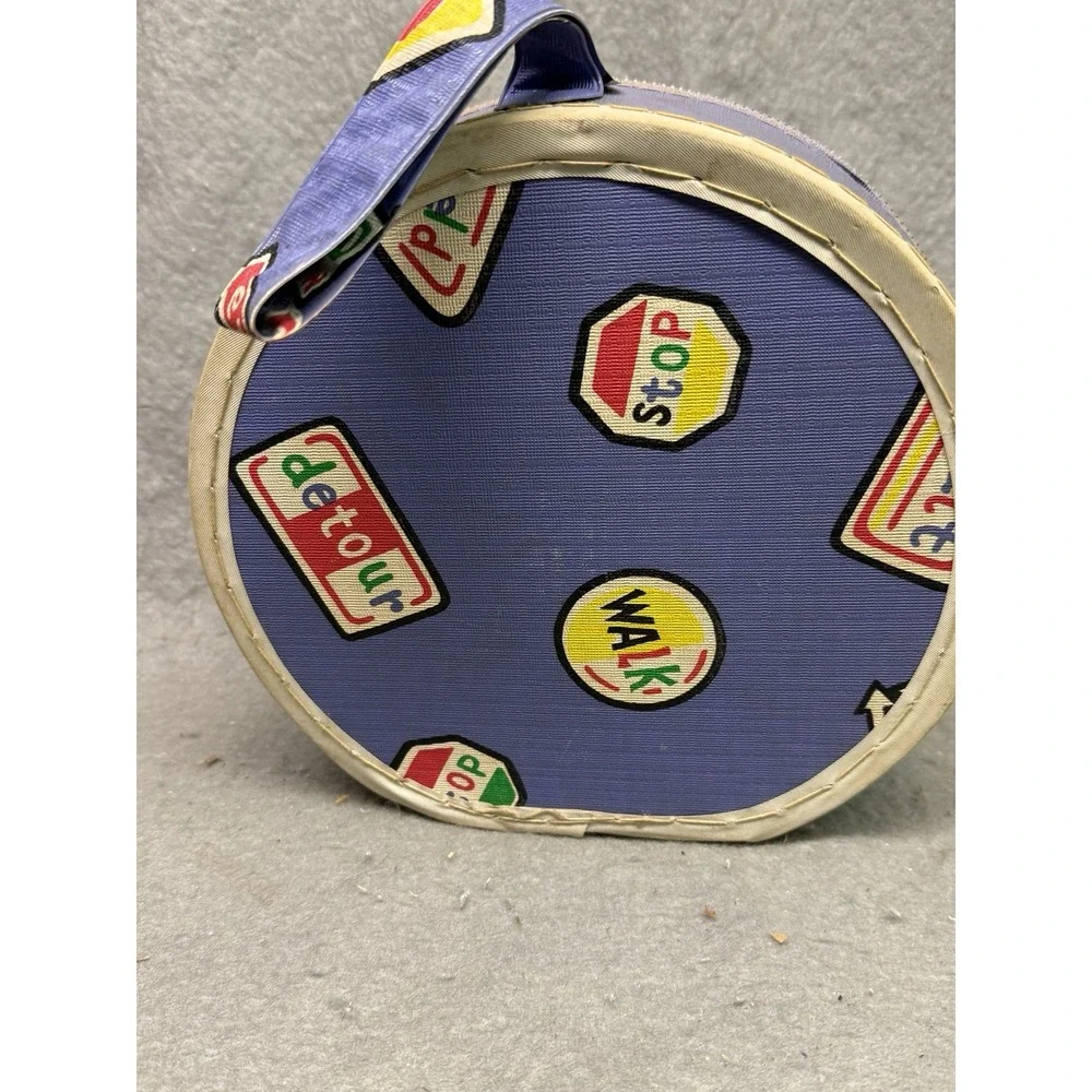 VINTAGE DOLL SUITCASE TRAFFIC SIGN PATTERN W/ MISC. CONTENTS DOLLS, TROLL, BIRDS